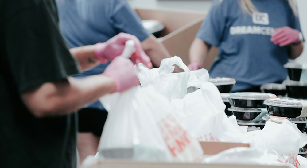 A man and child wrapped up warm playing in the snow