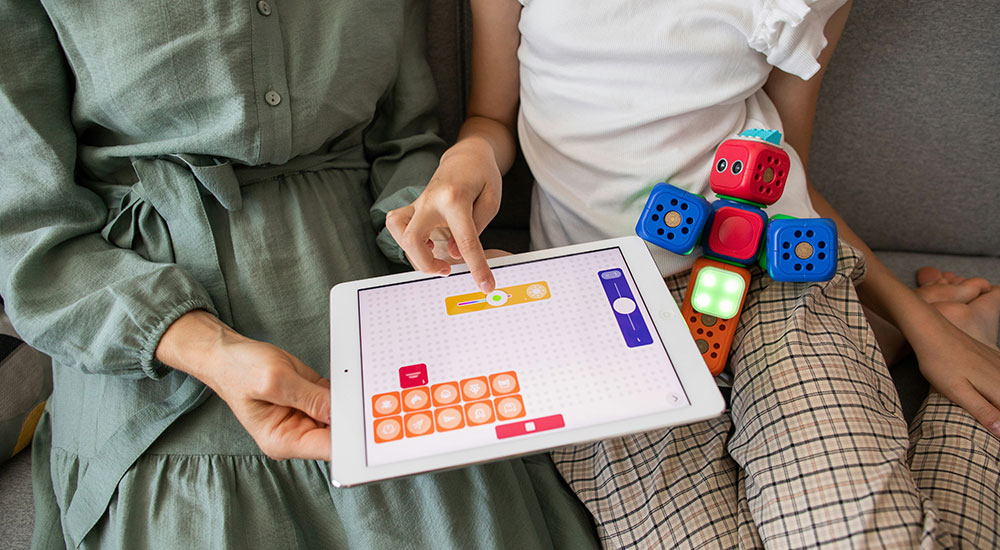 A woman sitting at a desk smiling